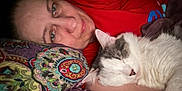 Hutuna joined the competition — help win amazing prizes! person, cat, sleeping, pillow, patterned_pillow, bed, resting, close_up, indoor, relaxation, animal, pet, face, human, comfort, cozy, red_shirt, whiskers, fur, nap