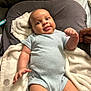 William joined the competition — help win amazing prizes! baby, infant, onesie, blanket, pillow, hand, smile, indoor, soft_texture, couch, person, skin, cute, happy, child, family, toddler, comfort, relax, cozy