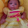 baby, infant, crochet_dress, yellow, hat, knitted_background, portrait, child, cute, newborn, person, smile, indoors, closeup, face, skin, hand, foot, fashion, colorful