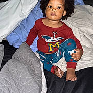 Omari joined the competition — help win amazing prizes! child, toddler, pajamas, blanket, bed, pillow, indoor, clothing, foot, hand, person, hair, cute, sleepwear, comfort, rest, young, portrait, cozy, expression