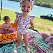 Manon participe au concours pour gagner de l'argent avec cette photo : toddler, child, swimsuit, bow, smiling, outdoor, blanket, toy, inflatable_pool, baby, water, grass, car, sunny, playtime, summer, happy, nature, family, park