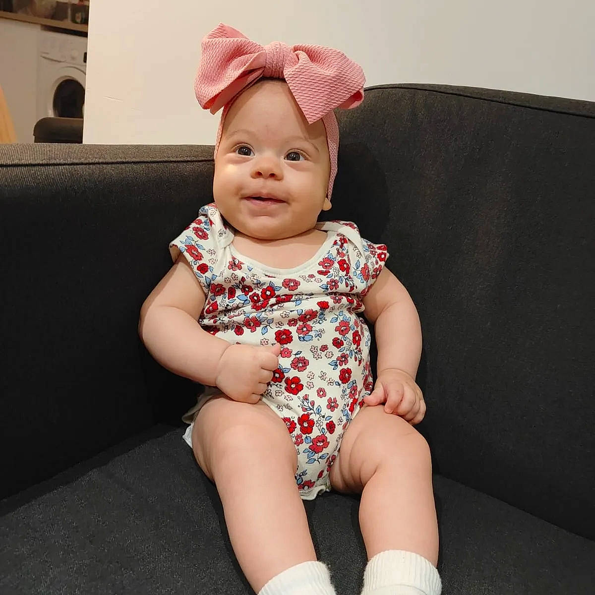 Luna is registered to the contest to win money with this photo: baby, baby_toddler_clothing, cap, cheek, chin, comfort, couch, eye, happy, head, headwear, human_leg, iris, knee, neck, pattern, person, skin, sleeve, smile