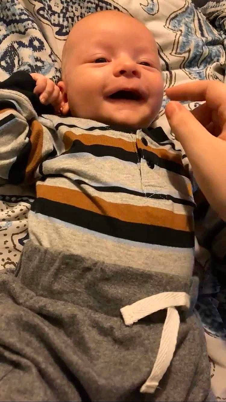 Lucas is registered to the contest to win money with this photo: baby, baby_toddler_clothing, black, brown, cheek, child, comfort, cool, eye, face, facial_expression, finger, fun, gesture, happy, head, mouth, person, skin, sleeve