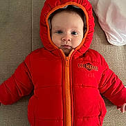 Noah a rejoint le concours — aidez-le/la à gagner de superbes lots ! baby, infant, child, hooded_jacket, red_jacket, zipper, face, eyes, sofa, cushion, pillow, indoors, portrait, laying_down, cute, warm_clothing, lee_cooper, tiny_hands, expression, cozy