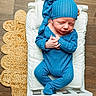 Oliver joined the competition — help win amazing prizes! newborn, baby, infant, sleeping, blue_outfit, blue_hat, crib, cushion, wooden_floor, woven_rug, hand_position, peaceful, cute, portrait, indoors, soft_lighting, cozy, small, child, resting