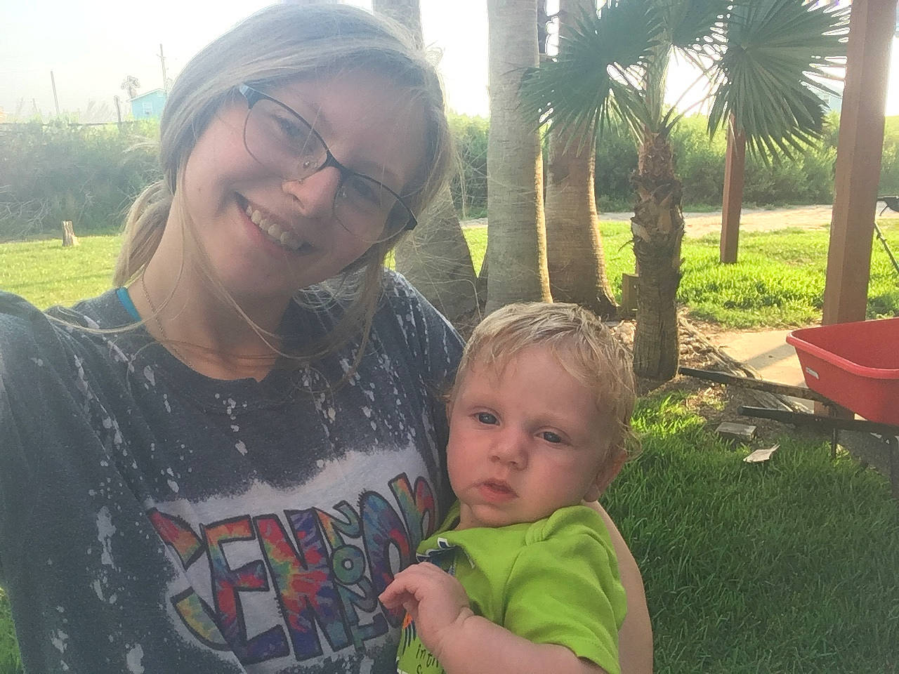 Graysen is registered to the contest to win money with this photo: botany, eyewear, face, fun, glasses, grass, happy, joy, leaf, leisure, mammal, person, photograph, plant, skin, smile, summer, t_shirt, toddler, tree