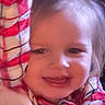 child, toddler, smiling, face, red_shirt, checkered_pattern, arm, happy, indoor, closeup, person, young_child, portrait, casual_clothing, hair, expression, cute, baby, childhood, cheerful