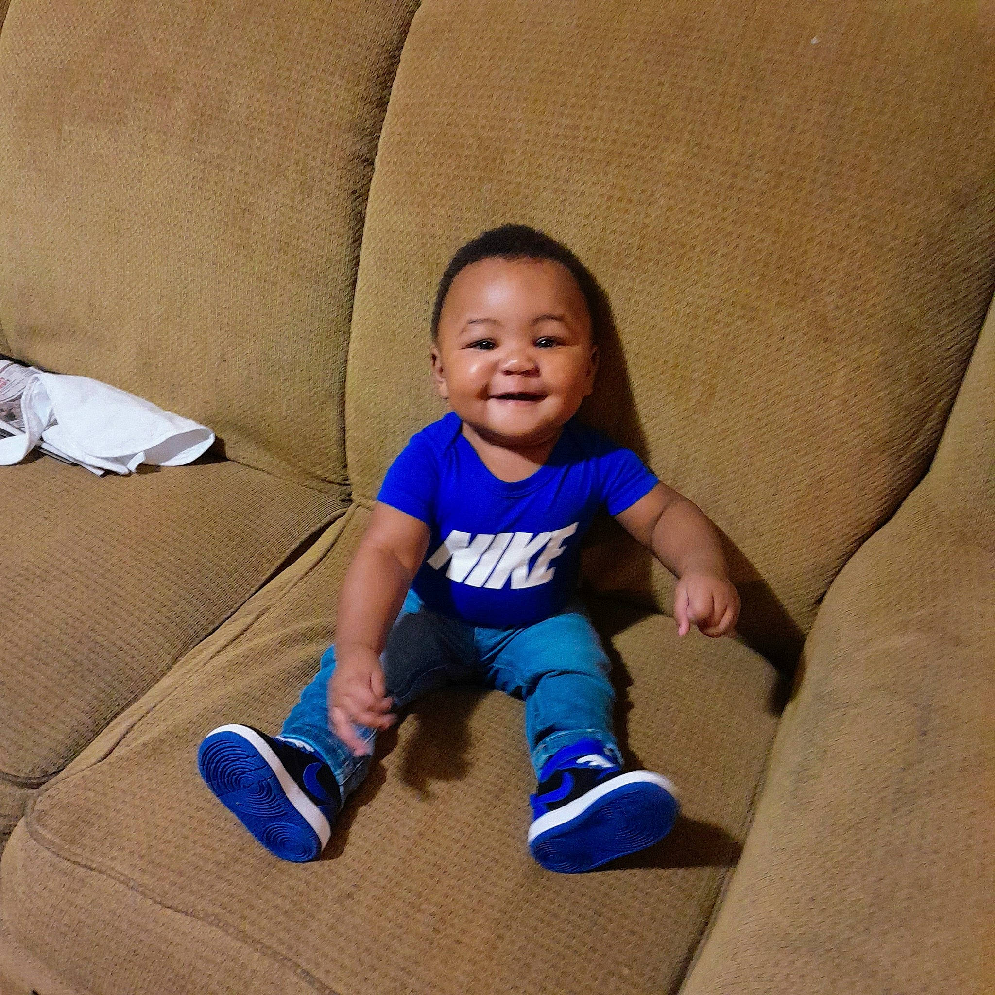 Kyrie joined the competition — help win amazing prizes! baby, baby_toddler_clothing, comfort, couch, electric_blue, eye, face, floor, flooring, foot, hair, happy, head, human_body, joy, knee, person, sleeve, smile, sock