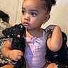 Jahira joined the competition — help win amazing prizes! toddler, child, baby, curly_hair, bun, pink_clothing, bracelet, earring, blanket, stars, moon, indoor, portrait, sitting, cute, expression, person, young_child, soft_lighting, cozy