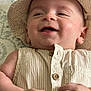 Theodore joined the competition — help win amazing prizes! baby, infant, smiling, hat, beige, clothing, sleeveless_shirt, button, hand, face, skin, cute, lying_down, closeup, portrait, happy, child, indoors, patterned_background, chubby_hand