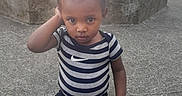 Iyair joined the competition — help win amazing prizes! child, toddler, portrait, outdoor, street, sitting, concrete, urban, striped_shirt, sportswear, sneakers, black_pants, braided_hair, serious_expression, direct_gaze, daylight, buildings, sidewalk, parked_cars, photography
