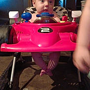 Andrew joined the competition — help win amazing prizes! baby, child, toy_car, walker, indoor, legs, face, curious, red, plastic, playtime, furniture, floor, shadow, arm, person, seat, head, expression, home