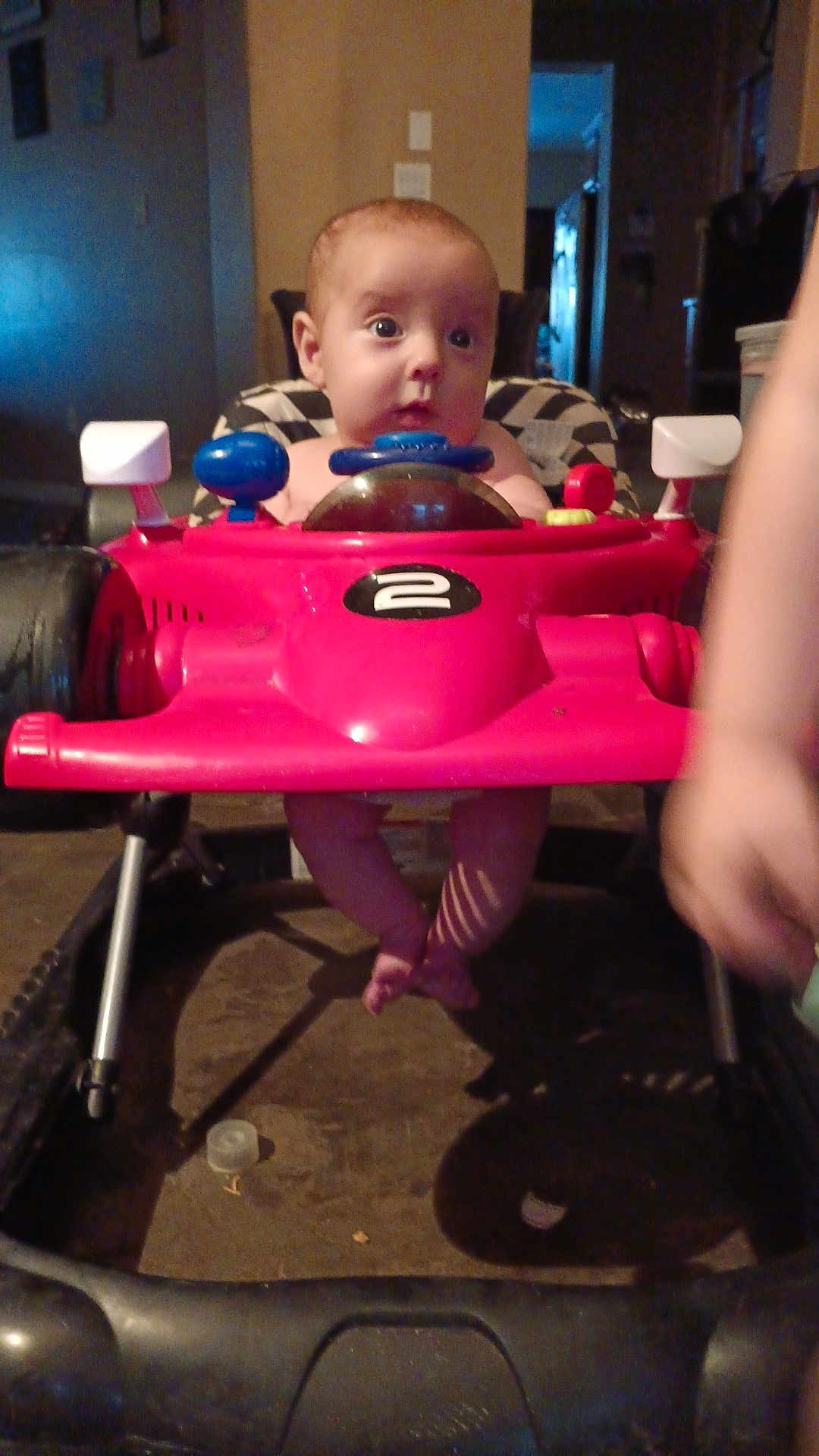 Andrew joined the competition — help win amazing prizes! baby, child, toy_car, walker, indoor, legs, face, curious, red, plastic, playtime, furniture, floor, shadow, arm, person, seat, head, expression, home