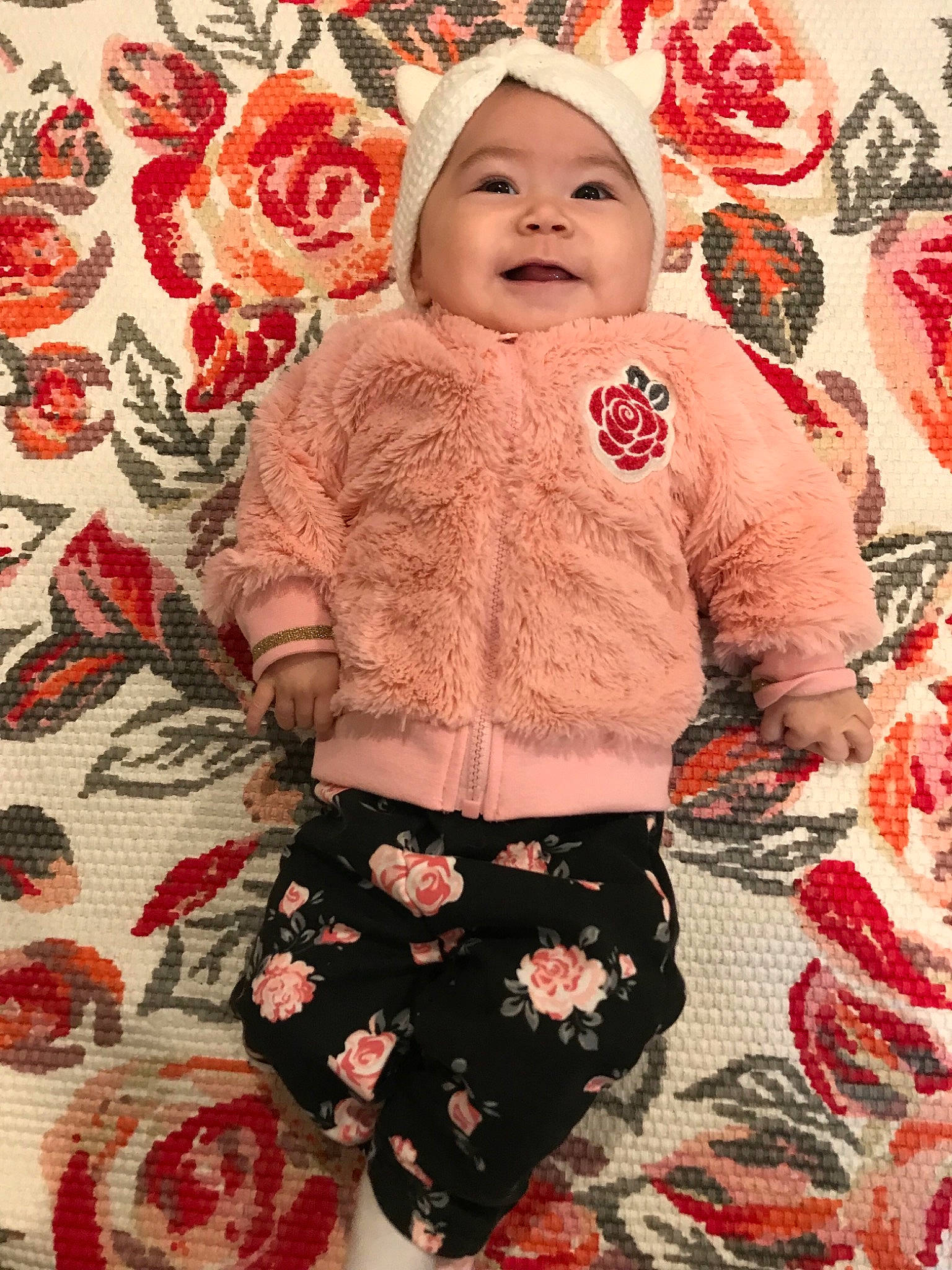Mavis is registered to the contest to win money with this photo: baby, child, headwear, outerwear, pattern, person, pink, sleeve, textile, toddler