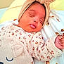 Miyah a rejoint le concours — aidez-le/la à gagner de superbes lots ! baby, newborn, sleeping, headwrap, onesie, blanket, cute, infant, portrait, closeup, soft_texture, nursery, peaceful, chubby_cheeks, hand, patterned_clothing, cartoon_print, cozy, pink_tones, adorable