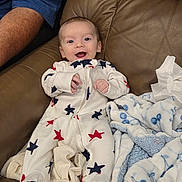Braxton joined the competition — help win amazing prizes! baby, infant, smile, sleeper, stars, blanket, couch, leather, person, arm, happy, cozy, indoor, child, cute, comfortable, clothing, relaxing, portrait, home