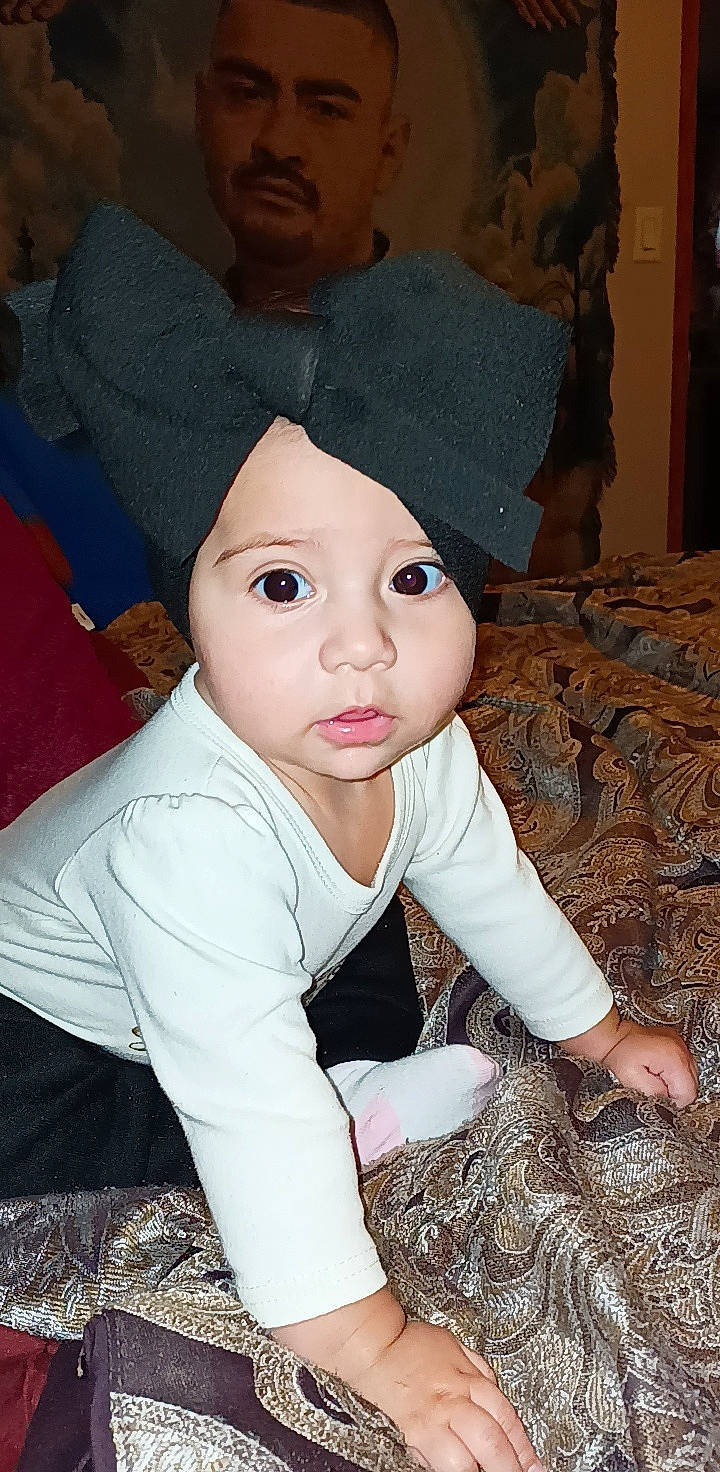 Elianna is registered to the contest to win money with this photo: baby, baby_toddler_clothing, beanie, bonnet, cap, cheek, child, costume_accessory, costume_hat, fashion_accessory, fun, fur, hat, headwear, knit_cap, pattern, person, portrait_photography, sitting, sleeve