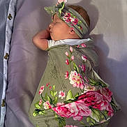 Nova joined the competition — help win amazing prizes! baby, sleeping, swaddled, blanket, headband, floral_pattern, crib, teddy_bear, soft, peaceful, infant, cute, cozy, bed, purple, child, portrait, wrapped, newborn, resting