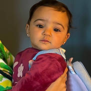 Khélissa participe au concours pour gagner de l'argent avec cette photo : toddler, child, face, portrait, earrings, backpack, maroon_clothing, holding_hand, person, indoor, closeup, cute, young_child, baby, human, expression, head_and_shoulders, skin, apparel, people