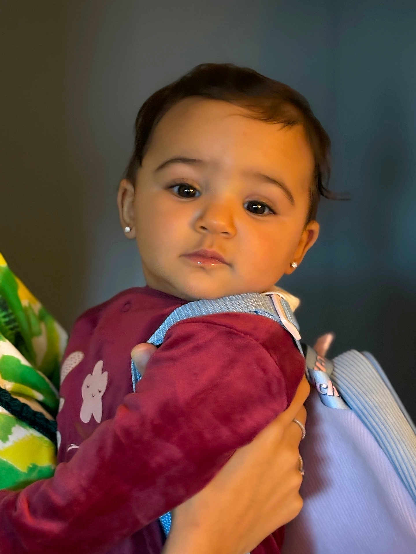 Khélissa participe au concours pour gagner de l'argent avec cette photo : toddler, child, face, portrait, earrings, backpack, maroon_clothing, holding_hand, person, indoor, closeup, cute, young_child, baby, human, expression, head_and_shoulders, skin, apparel, people