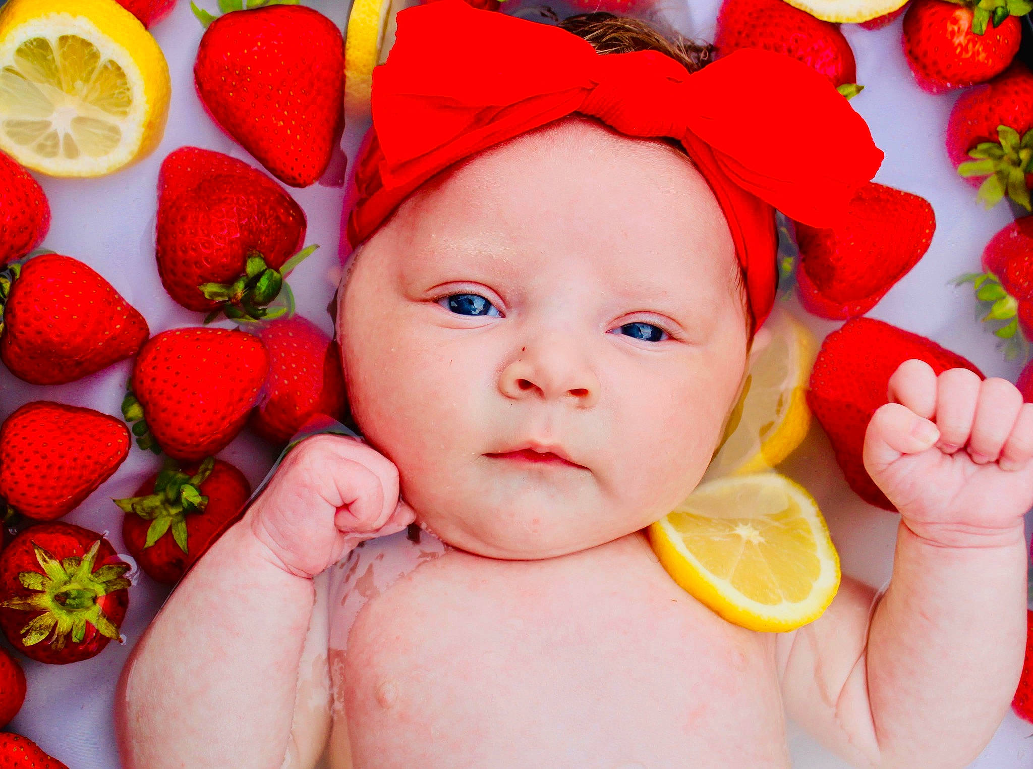 Alyvia joined the competition — help win amazing prizes! baby, cheek, child, finger, fruit, hair_accessory, hand, headwear, mouth, orange, person, photomontage, plant, red, skin, sweetness, toddler