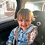 baby, blue_eyes, car_interior, car_seat, child, cute, denim_shirt, floral_pattern, hair, happy, indoor, person, portrait, safety, seatbelt, smile, sunlight, toddler, vest, window