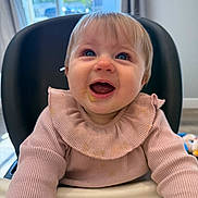Jaycee joined the competition — help win amazing prizes! baby, child, high_chair, smiling, happy, indoor, blue_eyes, messy_face, pink_sweater, long_sleeves, infant, cute, looking_up, tongue_out, cozy, home, daylight, furniture, feeding_time, adorable