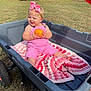 Jaycee is registered to the contest to win money with this photo: toddler, child, pink_overalls, bow, pumpkin, wagon, blanket, crochet, outdoor, grass, trees, sunny, smiling, happy, baby, playtime, nature, cute, sitting, toy