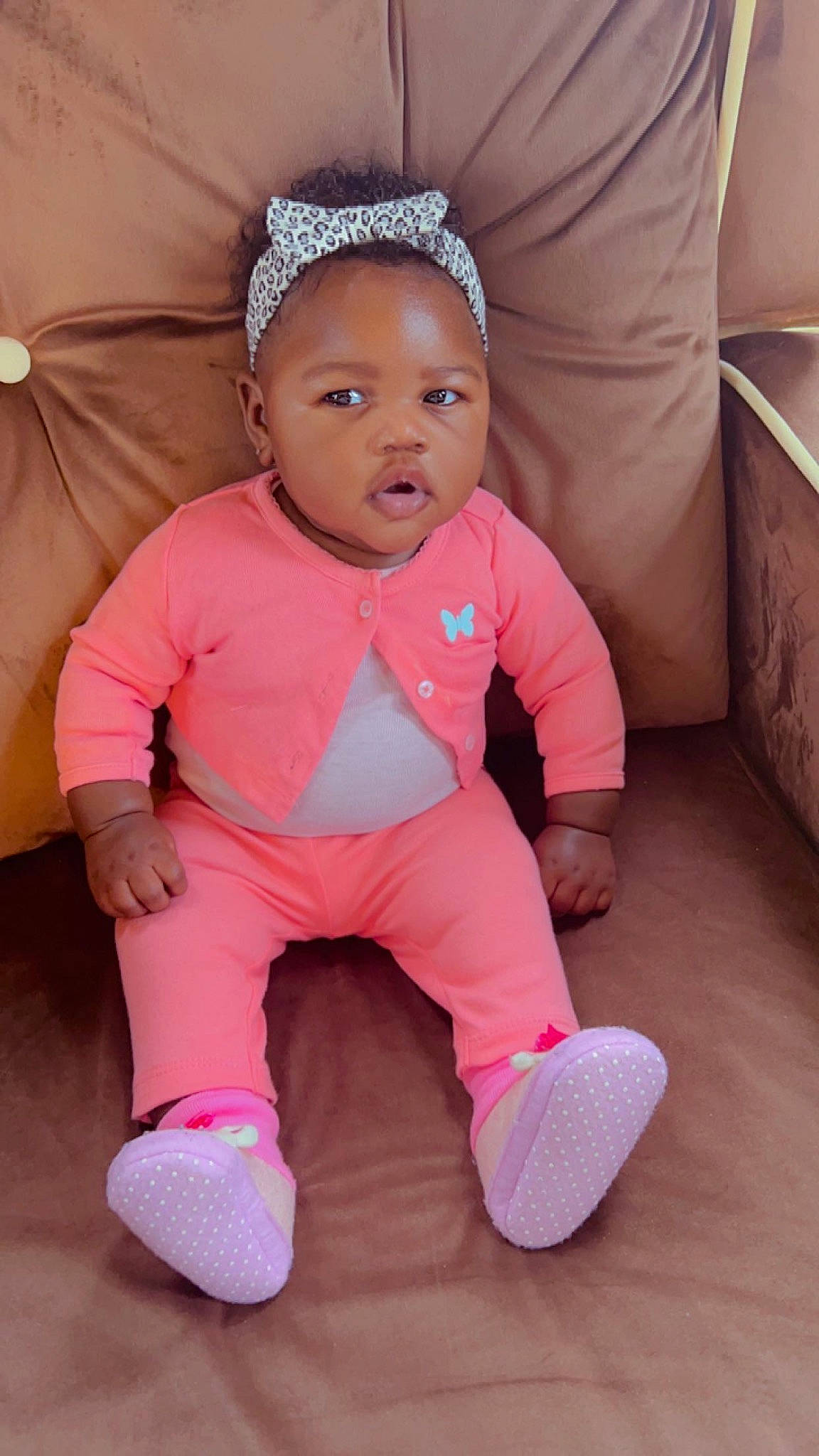 Majesty is registered to the contest to win money with this photo: baby, baby_products, baby_toddler_clothing, cheek, child, comfort, face, facial_expression, flooring, fun, happy, head, magenta, nose, person, pink, skin, sleeve, sock, toddler