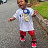 Zamir joined the competition — help win amazing prizes! toddler, child, smiling, walking, birthday_boy, nike, sneakers, red_shorts, white_tshirt, outdoor, street, sidewalk, green_grass, tree_trunk, earrings, happy, person, celebration, daylight, casual_clothing