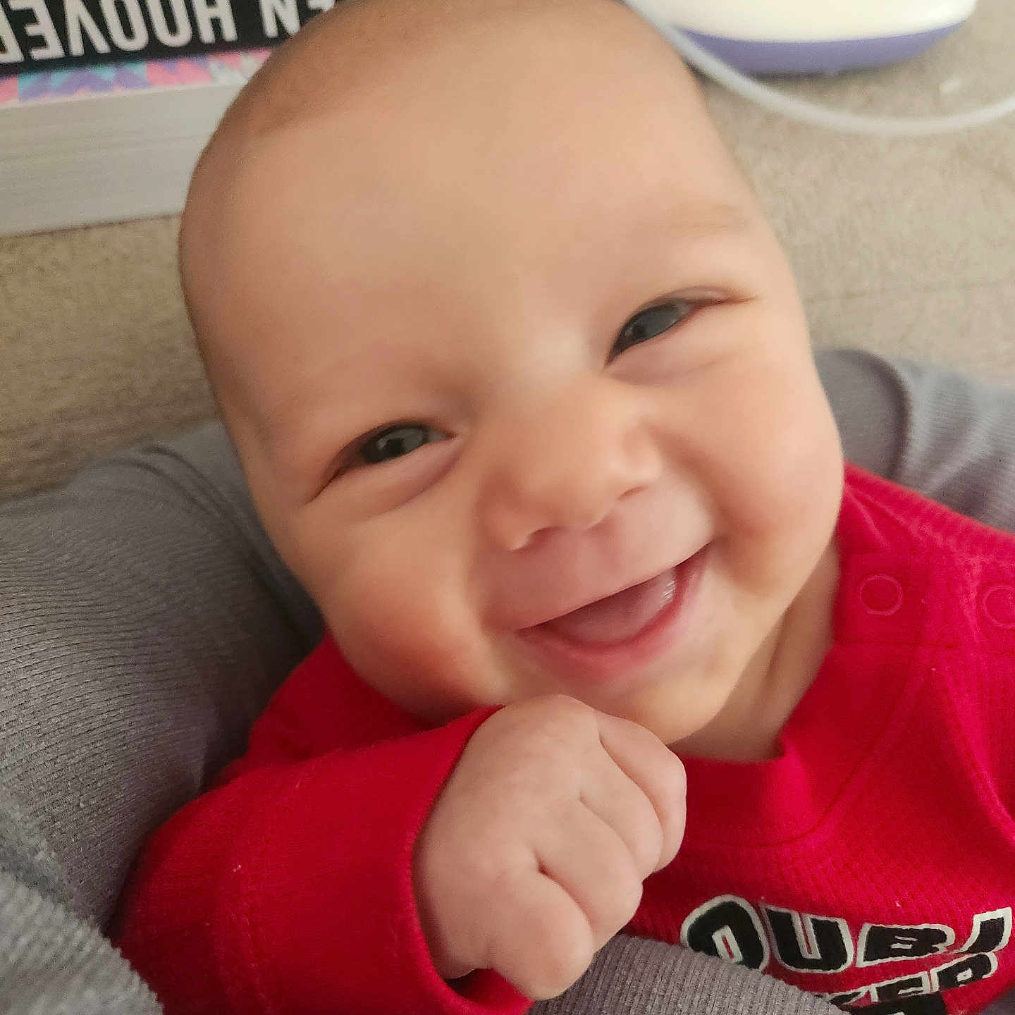 Blaine is registered to the contest to win money with this photo: baby, babylaughing, bodypart, clothing, cushion, face, finger, hand, happy, head, homedecor, laughing, mouth, newborn, person, photography, portrait, smile, t_shirt, teeth