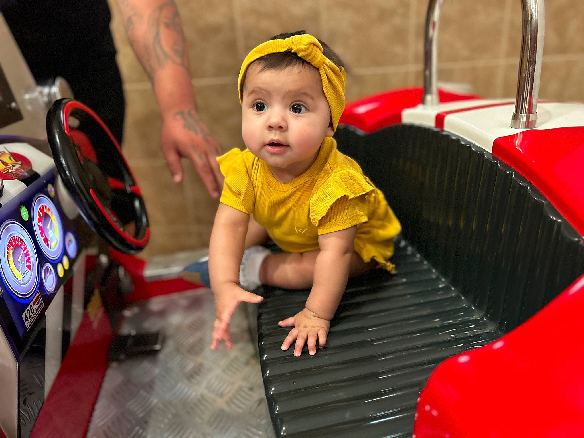 Aiyana is registered to the contest to win money with this photo: auto_part, automotive_design, automotive_exterior, automotive_tire, automotive_wheel_system, baby, baby_products, baby_toddler_clothing, child, flooring, fun, happy, headwear, leisure, motor_vehicle, person, product, recreation, skin, tire