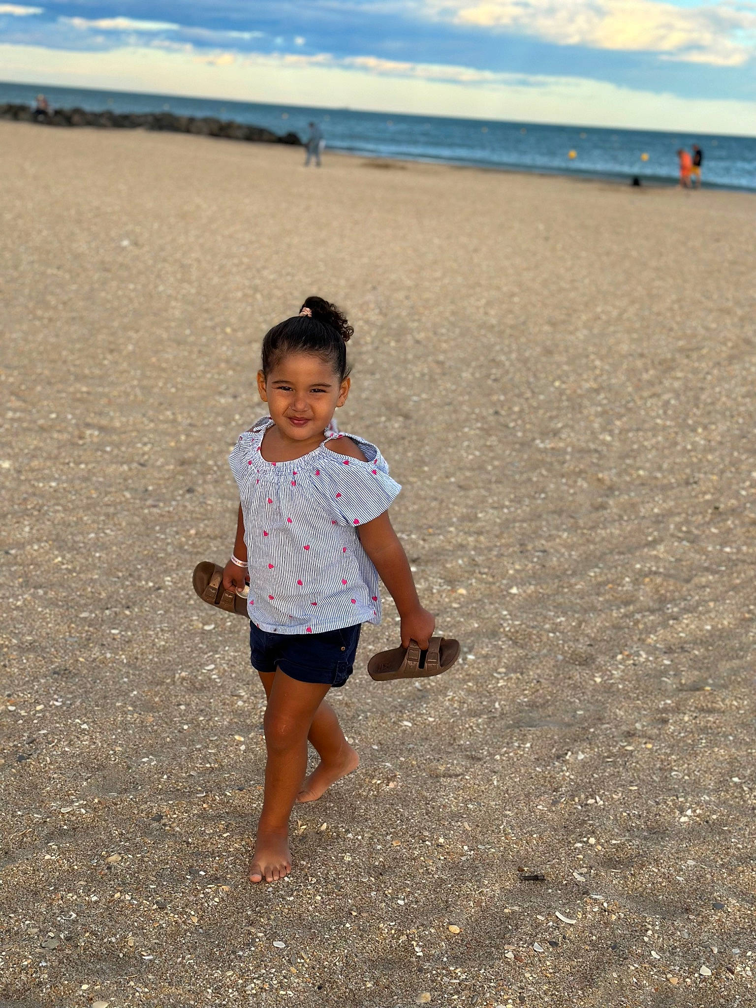 Ynaïa participe au concours pour gagner de l'argent avec cette photo : beach, cloud, coastal_and_oceanic_landforms, fun, happy, joy, landscape, leg, leisure, morning, natural_environment, nature, people_in_nature, people_on_beach, person, sand, sky, standing, sunlight, toddler