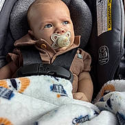 Stetson joined the competition — help win amazing prizes! baby, child, pacifier, car_seat, blanket, blue_eyes, infant, clothing, seatbelt, safety, portrait, cute, indoor, closeup, head, face, expression, soft_texture, warm, infant_care