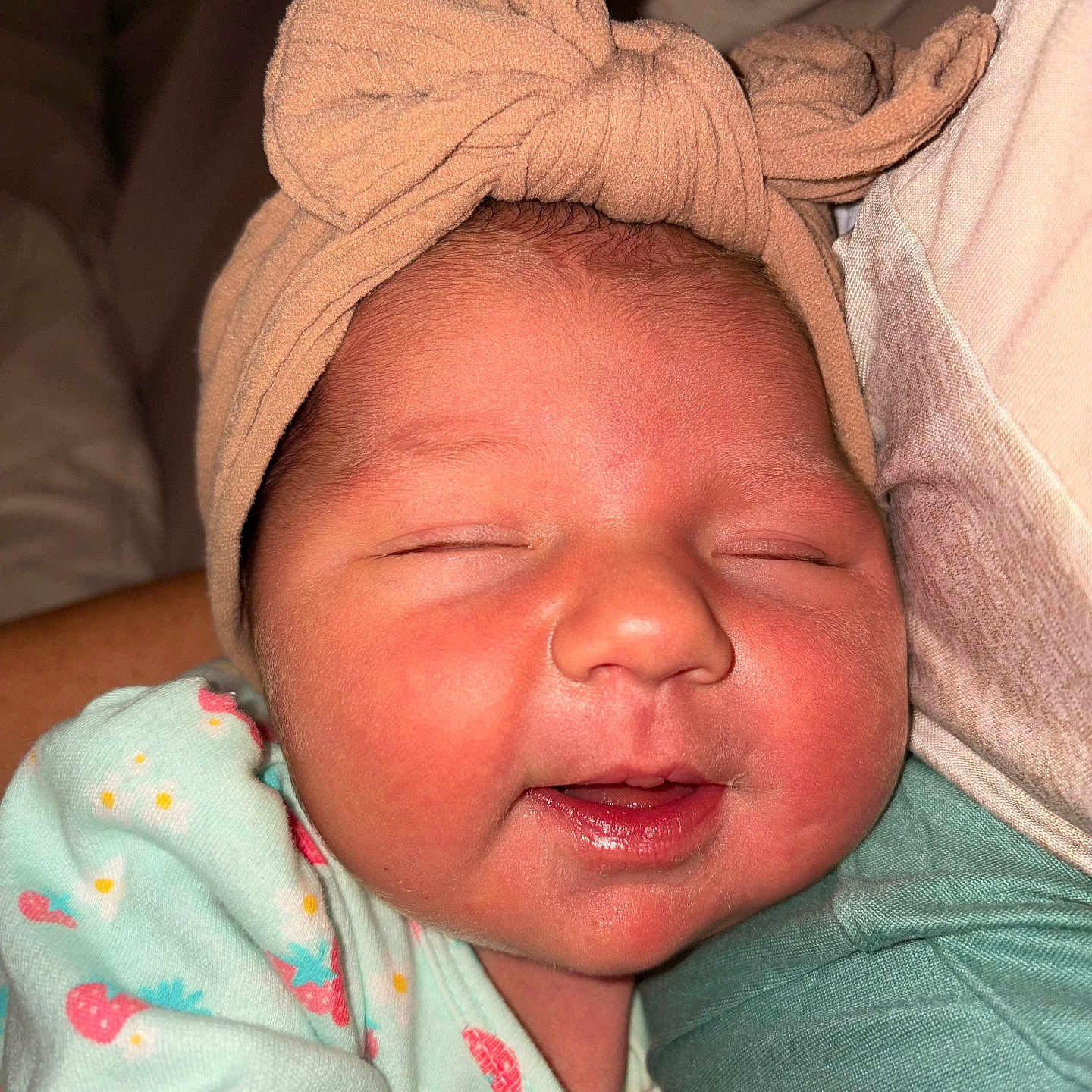 Madilynn is registered to the contest to win money with this photo: arm, baby, child, closeup, comfort, cute, face, headwrap, indoors, infant, newborn, onesie, peaceful, person, portrait, resting, skin, sleeping, smiling, soft