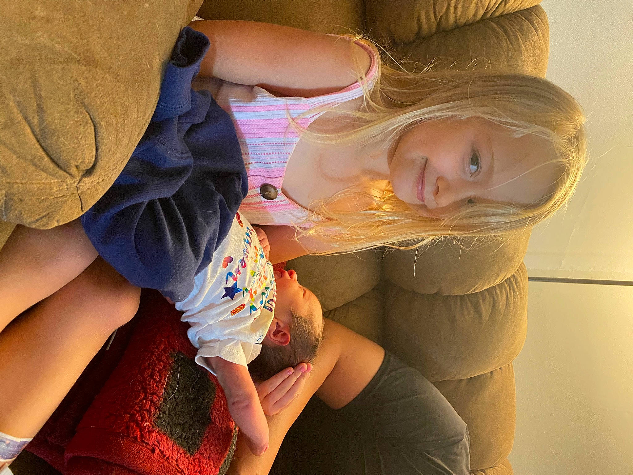 Kylee is registered to the contest to win money with this photo: abdomen, baby, blond, brown_hair, child, comfort, elbow, electric_blue, fun, gesture, happy, human_leg, joint, joy, knee, lap, nail, person, sitting, thigh