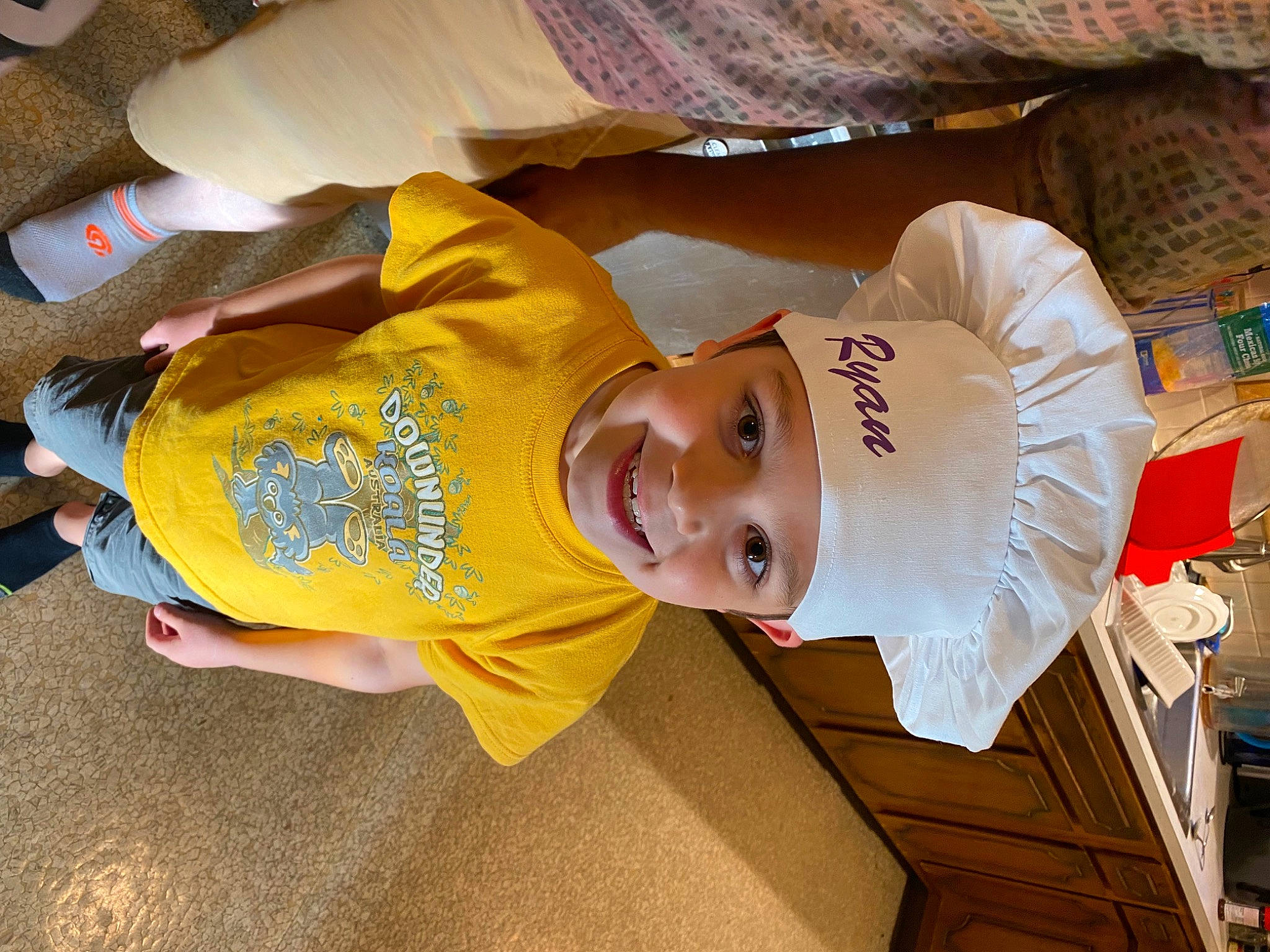 Ryan is registered to the contest to win money with this photo: baby_toddler_clothing, child, cricket_cap, fun, happy, hat, headwear, joy, orange, person, sleeve, smile, t_shirt, toddler, white, wood
