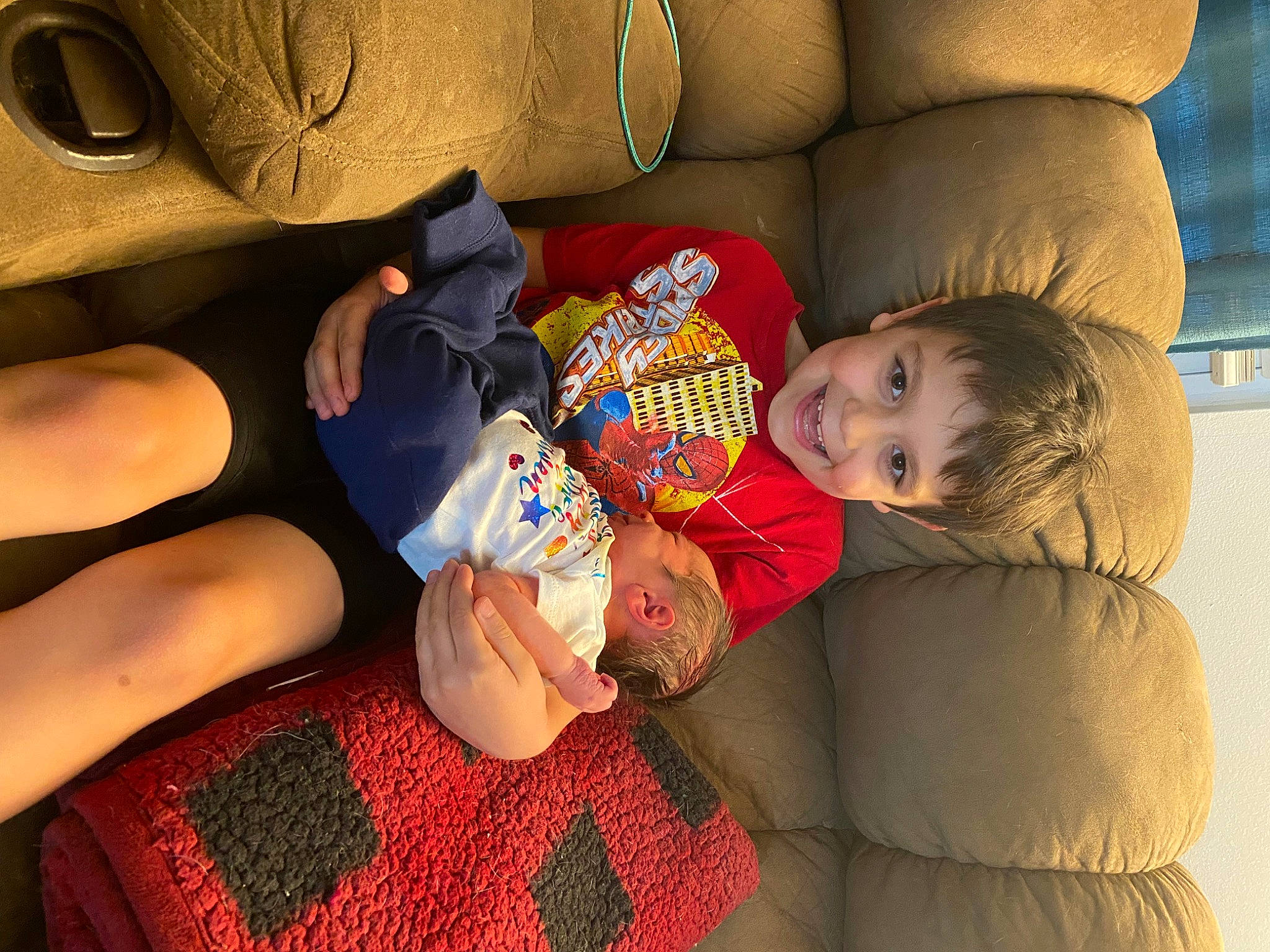 Ryan is registered to the contest to win money with this photo: arm, baby, comfort, couch, eye, face, finger, fun, hand, hat, head, human_body, human_leg, joy, lap, leg, mouth, nail, person, skin