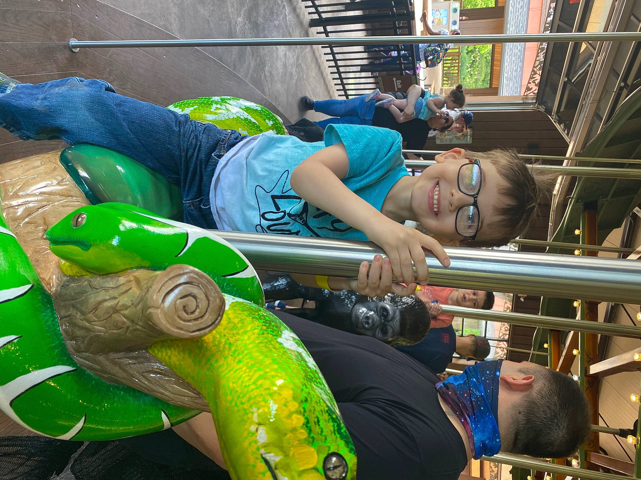 Noah joined the competition — help win amazing prizes! art, artist, blue, city, event, eyewear, fun, green, hat, human_leg, joy, leisure, person, personal_protective_equipment, plastic, recreation, sandal, shorts, sitting, sunglasses