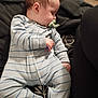 Stanley joined the competition — help win amazing prizes! baby, sleeping, pacifier, onesie, striped_clothing, child, infant, soft_surface, black_clothing, hand, face, head, leg, comfort, rest, indoors, candid, closeup, person, peaceful