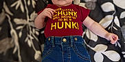 Stanley joined the competition — help win amazing prizes! baby, infant, clothing, jeans, tshirt, lying_down, blanket, pattern, floral, person, cute, child, casual, indoor, blue_jeans, maroon_shirt, small_child, young_baby, apparel, relaxed