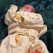 Amelia joined the competition — help win amazing prizes! baby, infant, pajamas, winnie_the_pooh, pacifier, blanket, green_quilt, sleepwear, child, cute, lying_down, soft_fabric, home_interior, comfort, resting, clothing, person, portrait, bedroom, young_child