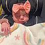 Amelia is registered to the contest to win money with this photo: baby, sleeping, headband, bow, car_seat, blanket, rainbow_pattern, star_pattern, infant, child, peaceful, indoors, soft_texture, cute, closeup, wrapped, resting, toddler, person, young_child