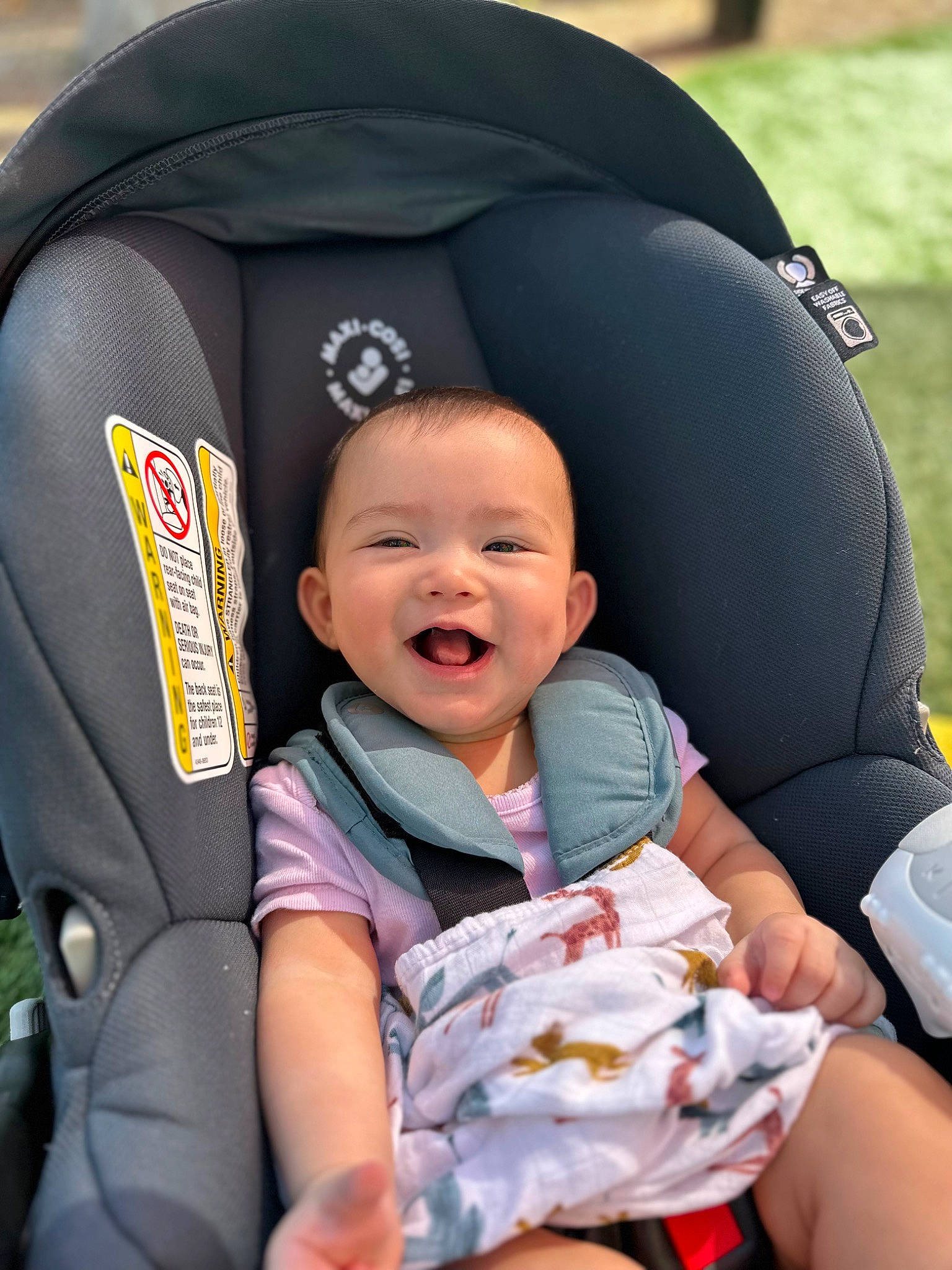 Victoria is registered to the contest to win money with this photo: auto_part, baby, baby_carriage, baby_in_car_seat, baby_products, baby_toddler_clothing, car_seat, child, comfort, event, finger, fun, gesture, happy, head_restraint, person, sitting, skin, smile, toddler