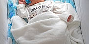 Nolan participe au concours pour gagner de l'argent avec cette photo : baby, bed, blanket, blue, child, clothing, cozy, crib, cushion, cute, indoors, infant, newborn, pacifier, peaceful, portrait, resting, sleeping, soft, white