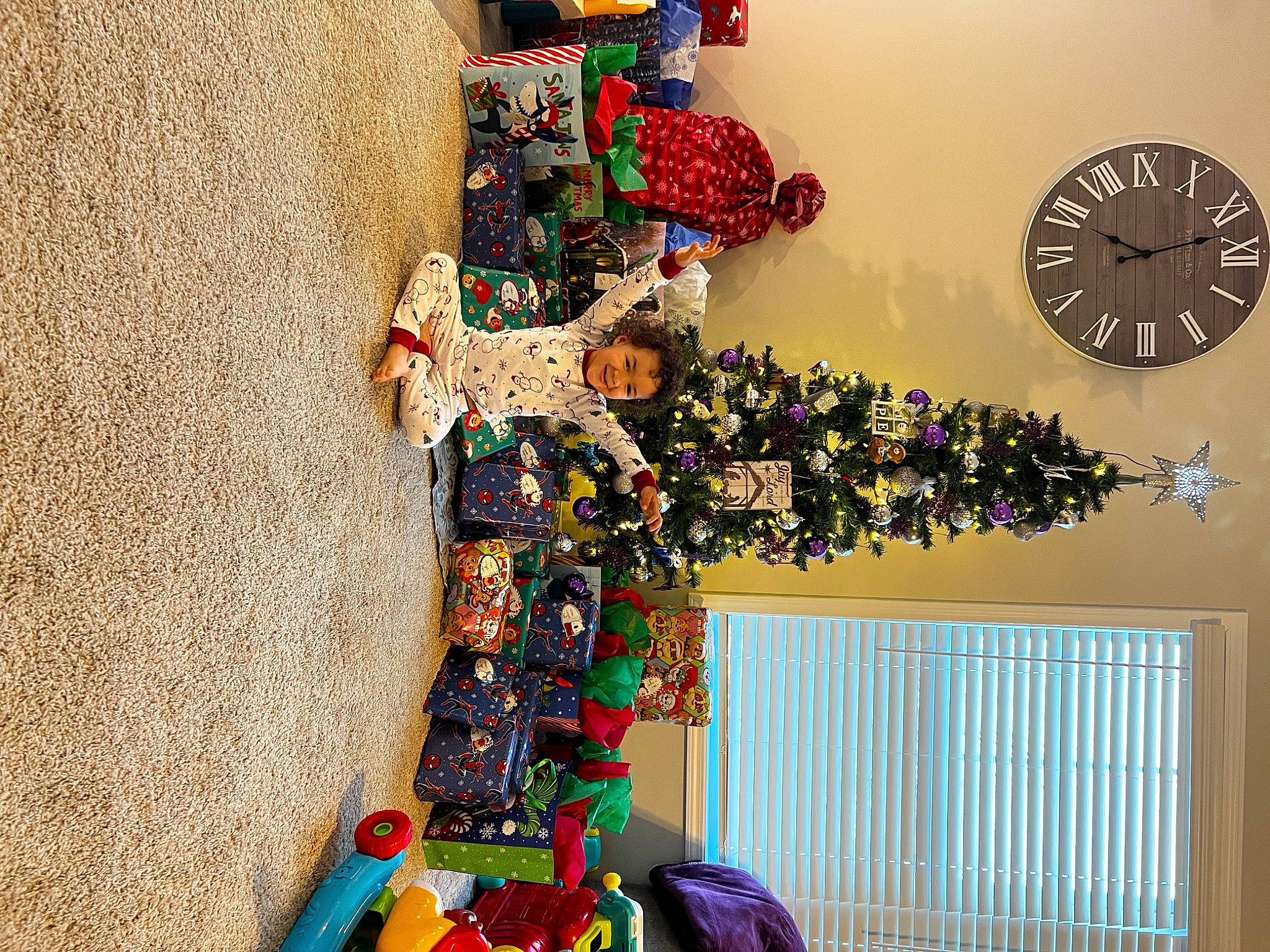 Khalil is registered to the contest to win money with this photo: art, carmine, christmas_decoration, christmas_ornament, christmas_tree, clock, creative_arts, decoration, event, fashion_accessory, interior_design, joy, ornament, person, plant, plastic, red, room, textile, tree