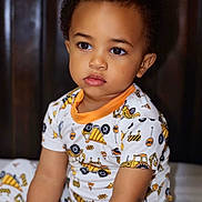 Ikana joined the competition — help win amazing prizes! toddler, child, pajamas, construction_theme, sitting, indoor, portrait, cute, young_child, curly_hair, face, expression, clothing, bed, furniture, person, skin, eyes, lips, home