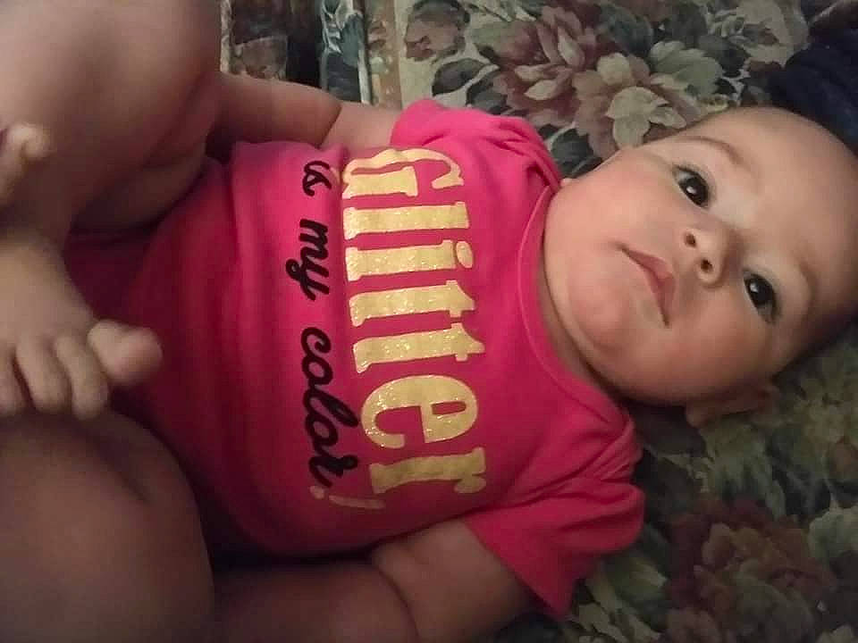 Rebecca is registered to the contest to win money with this photo: arm, baby, cheek, child, cool, eye, face, facial_expression, finger, forehead, hand, happy, head, lip, mouth, nose, person, pink, skin, smile