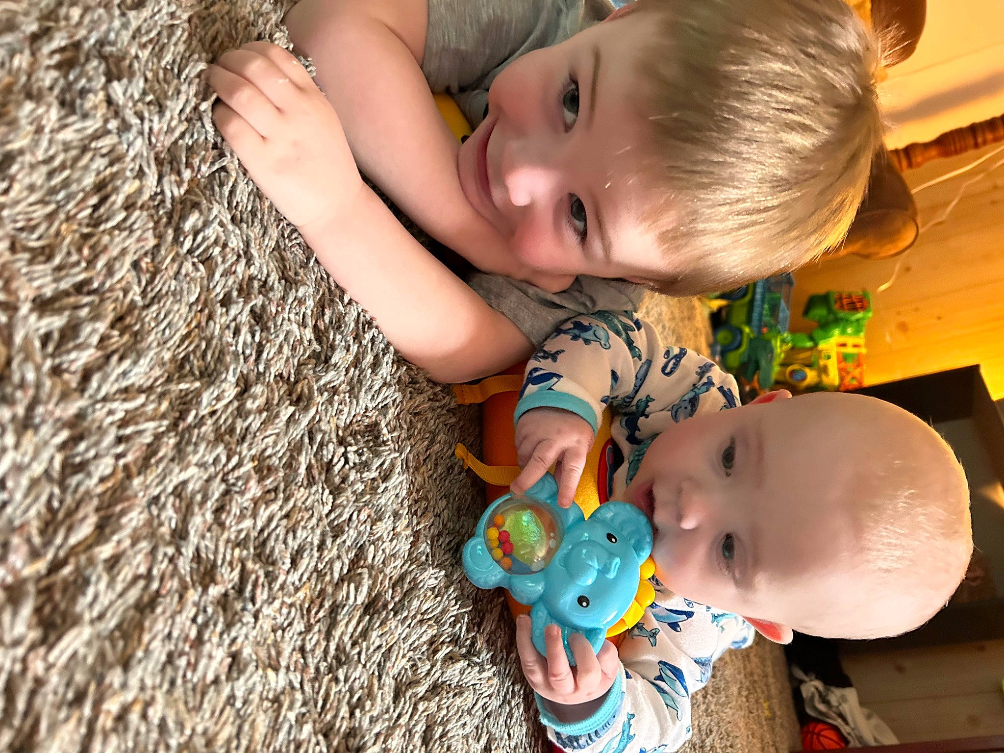Marcus is registered to the contest to win money with this photo: baby, baby_products, baby_toddler_clothing, baby_toys, cheek, child, finger, flooring, fun, grass, happy, iris, nail, people_in_nature, person, product, skin, textile, toddler, toy