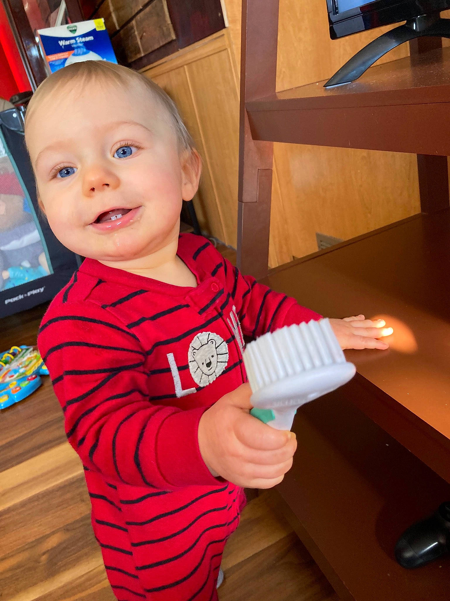 Joel is registered to the contest to win money with this photo: baby, baby_toddler_clothing, child, computer_keyboard, electronic_device, finger, fun, gadget, hand, happy, joy, nail, person, play, room, sitting, sleeve, smile, t_shirt, thumb